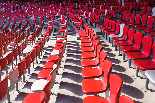 istock Red chairs bleachers in large stadium 480298851
