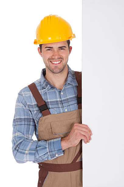 istock Worker wearing hard hat and holding empty banner 480299153