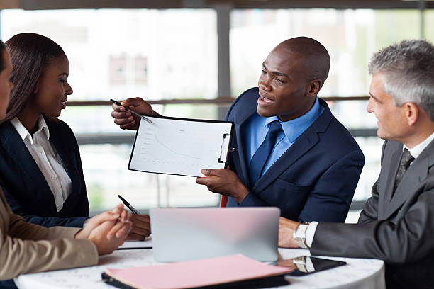 young african american businessman presenting figures at a meeting