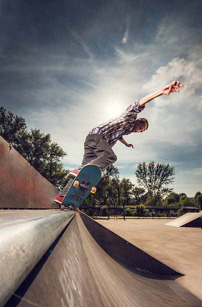istock Young skateboarder on a skate ramp in the park. 480304424