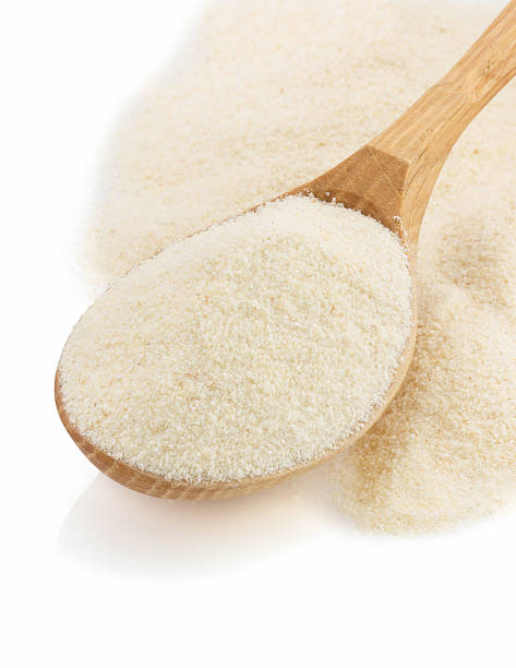 istock semolina flour in spoon on white 480307369