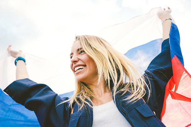 istock Cheering Woman Under Russian Flag 480310624