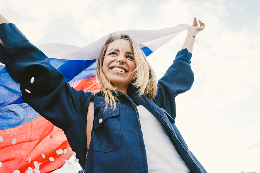 Cheering woman under Russian flag.