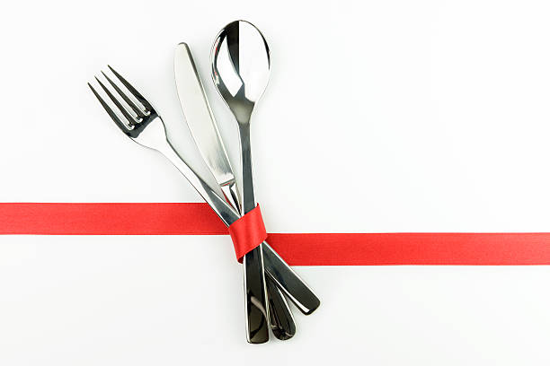 istock Fork, knife and spoon tied up with red ribbon 480311171
