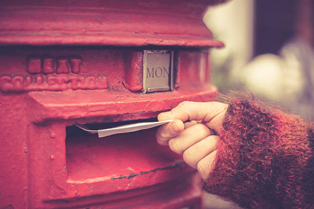 Woman posting letter stock photo