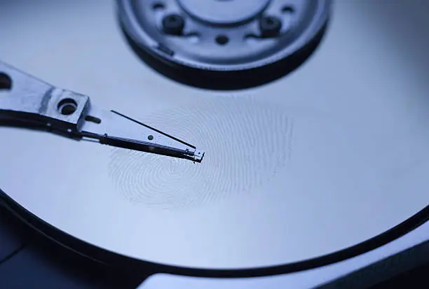 Fingerprint on a blue hard disk surface.