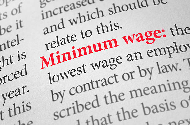 Definition of the word Minimum wage in a dictionary stock photo