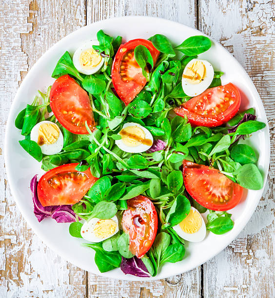 istock fresh green salad with lamb's lettuce, tomatoes and quail eggs 480321820