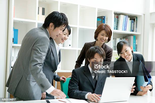 Man And Woman Looking At Pc Foto de stock y más banco de imágenes de Japonés - Oriental - Japonés - Oriental, PC de escritorio, Negocio