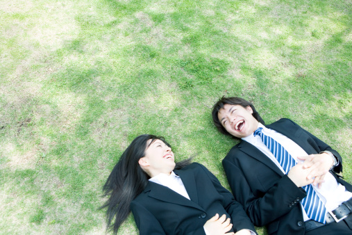 Man and woman lying on lawn