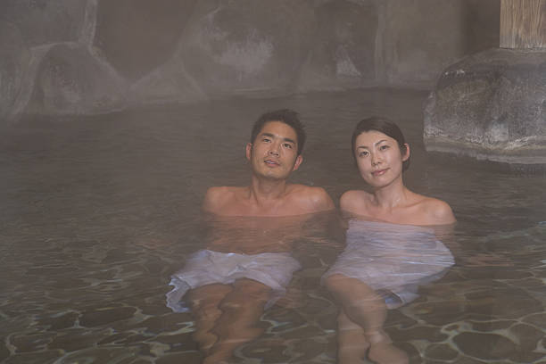 Man and woman in hot spring stock photo