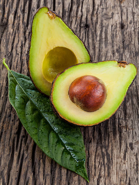 istock Halved avocado with core. - in macro shot. 480326756