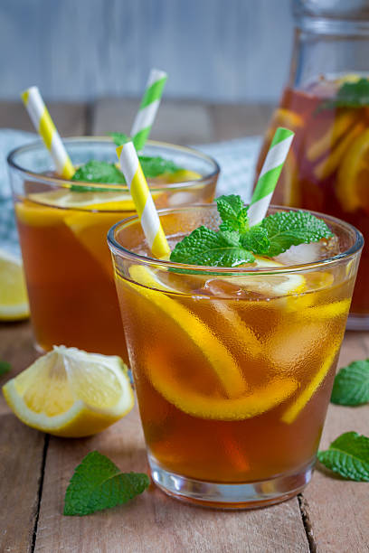 Refreshing homemade lemon iced tea on a wooden table