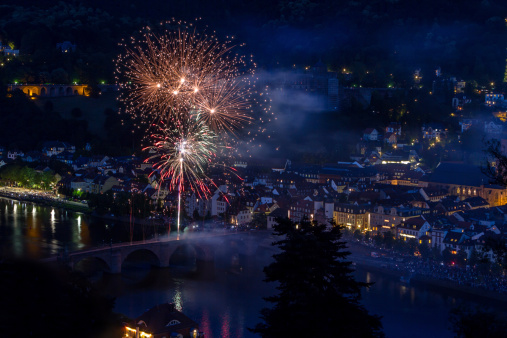Brightly colorful fireworks and salute of various colors in the night sky in Heidelberg, Germany