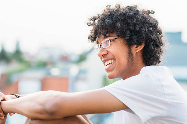 istock profil young man with afro in front of urban background 480330024