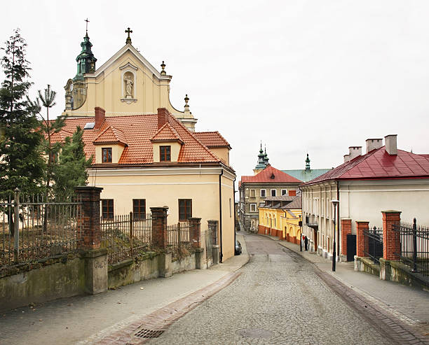Bialystok, Poland - April 30, 2012: Historic buildings and tourist attractions on central square of Kosciusko Market. Sunset on spring evening in Western Europe. Granite cobblestone pavement