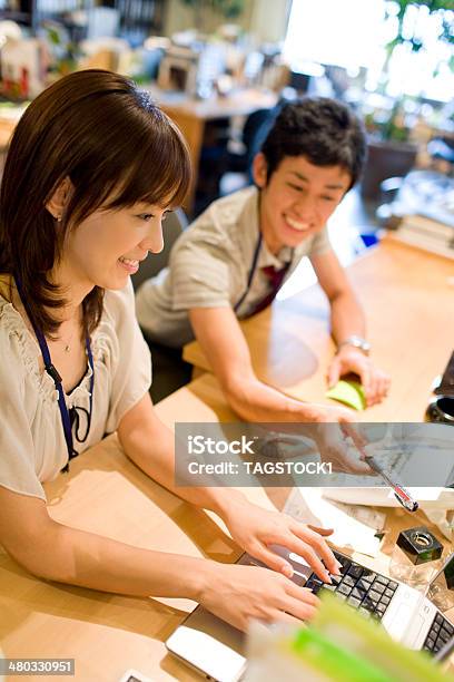 Man And Woman At Desk With Pc Stock Photo - Download Image Now - Asian and Indian Ethnicities, Office, 20-29 Years