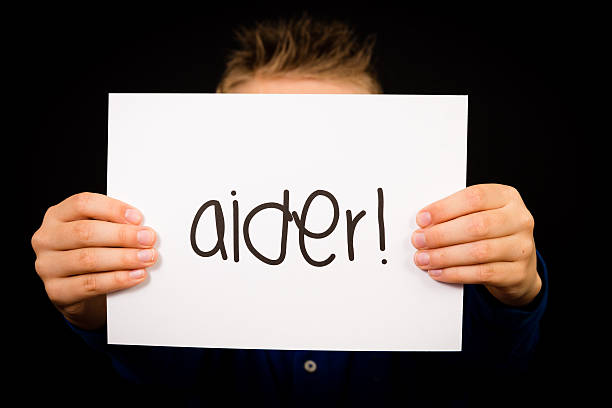 istock Child holding sign with French word Aider - Help 480331720