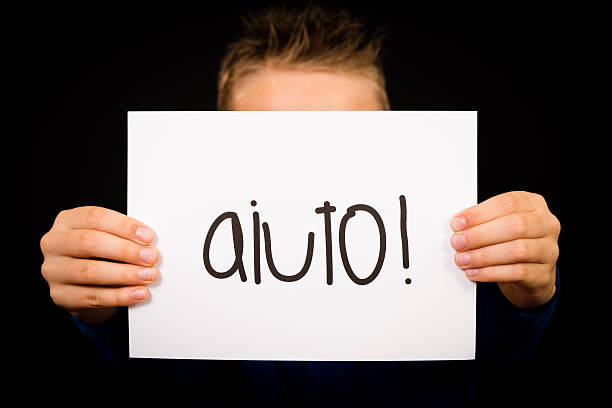 istock Child holding sign with Italian word Aiuto - Help 480331724