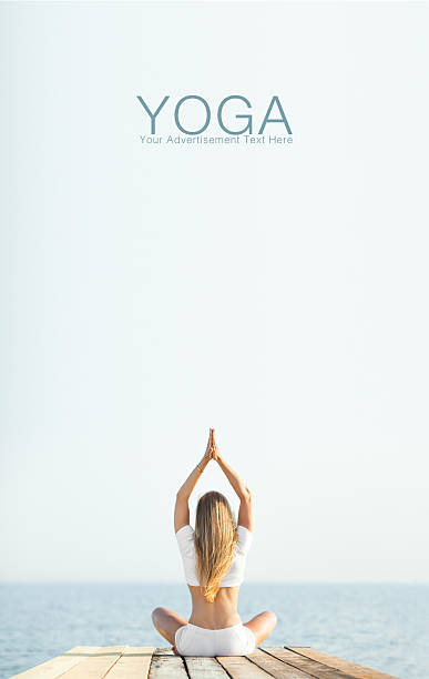 istock Beautiful blond woman practicing yoga at seashore and meditating 480333504