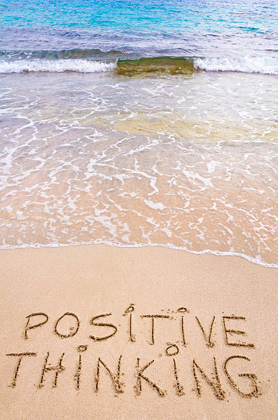 istock Positive Thinking message written on sand, with waves in background 480334987