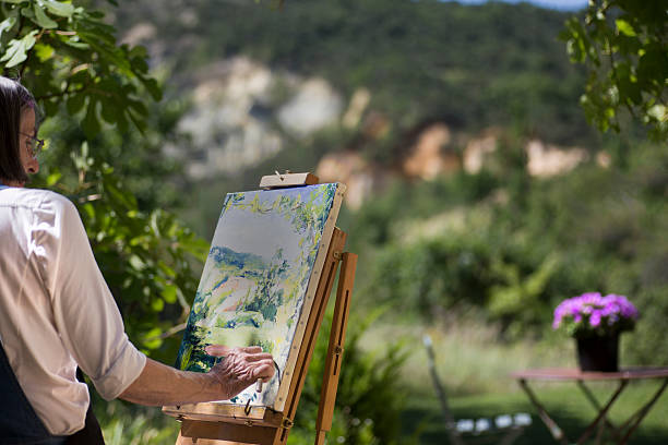 istock Woman painting at an easel 480337412