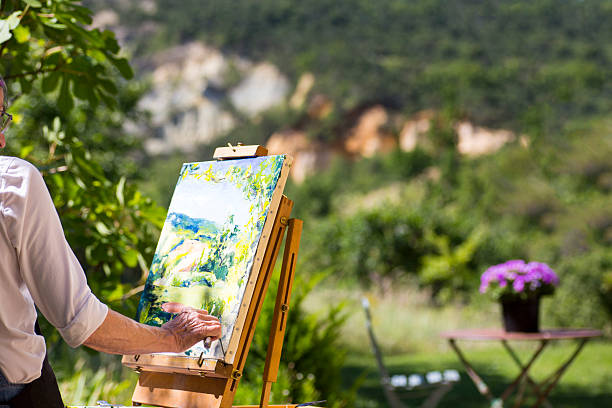 istock Woman painting at an easel 480337416