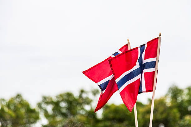 Two Norwegian flags blowing in the wind stock photo