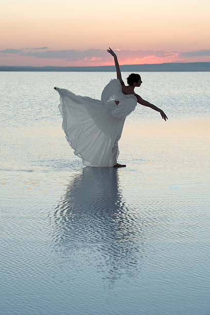 istock Aesthetic dancing on the beach with with angel outfit 480338550