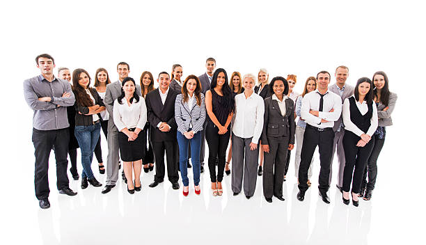 Large group of smiling business people looking at the camera. Team of happy business people standing together and looking at the camera. Isolated on white. large group of people facing camera stock pictures, royalty-free photos & images