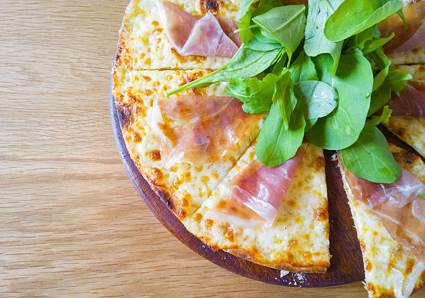 itallian pizza parma ham on wood dish