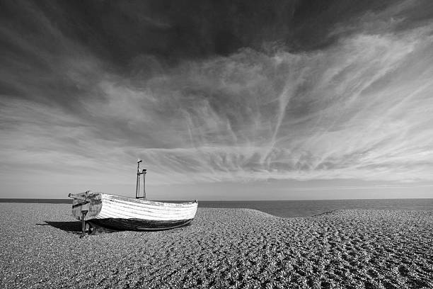 Black and white image of a fishing boat on Aldeburgh Beach in Suffolk, England