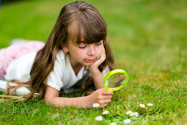 istock Girl with magnifying glass 480343508