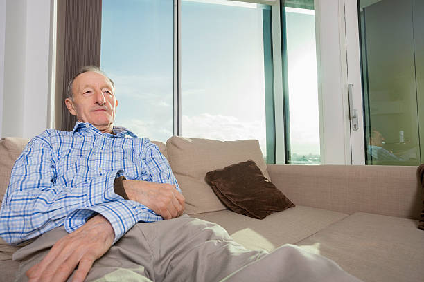 istock Senior man relaxing on sofa at home 480344517