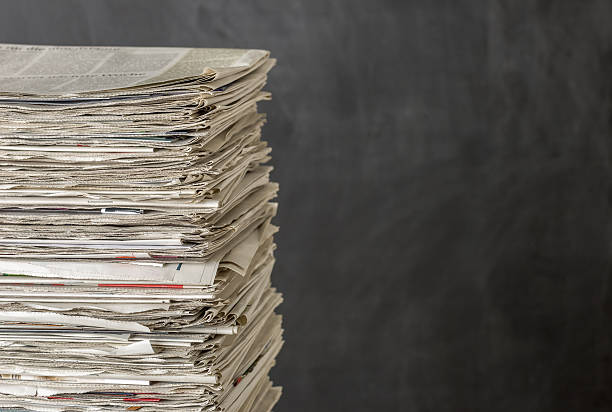 istock Pile of newspapers on a dark background 480344518