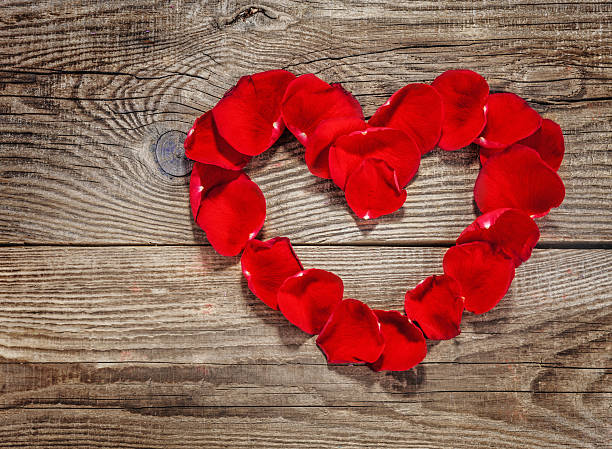 istock Heart of rose petals on the old boards and copyspace 480344632