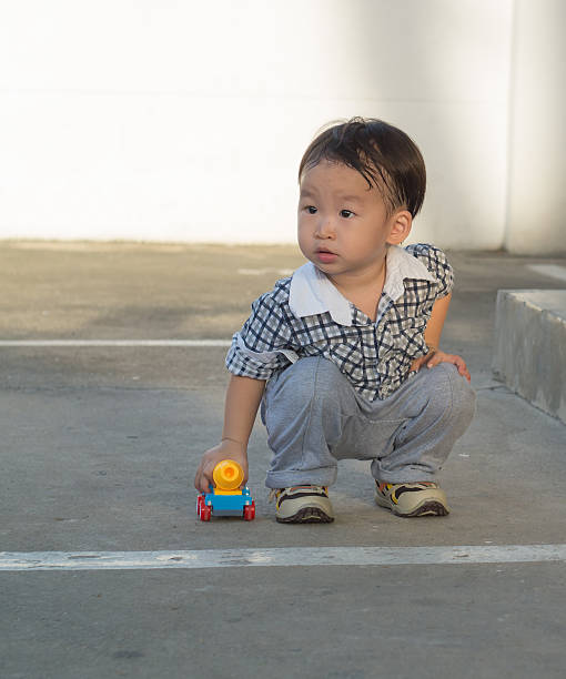 istock Little boy playing with toy car 480347692