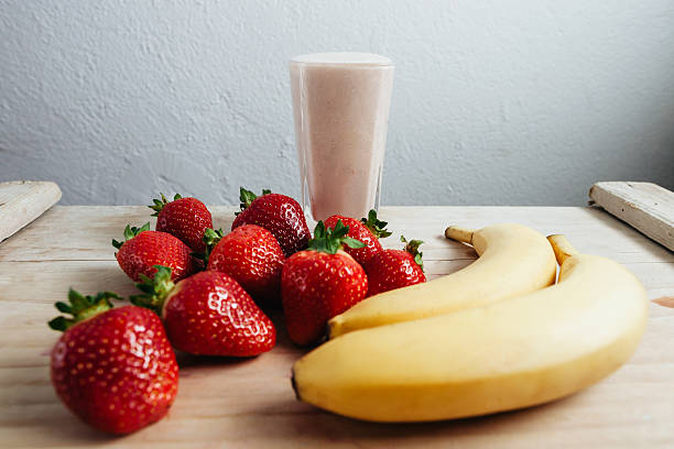 istock strawberry banana smoothie fresh blended on wood table 480353546