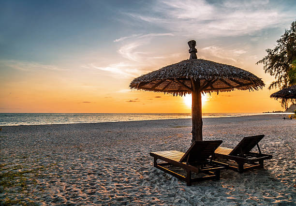 istock Wooden chairs and umbrellas on sand beach 480355646