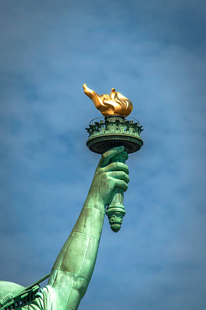 The torch of Lady Liberty Closeup of the torch of Lady Liberty on a cloudy day statue of liberty new york city photos stock pictures, royalty-free photos & images