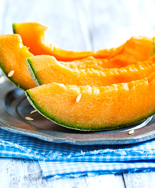 istock Cantaloupe melon slices on metal rustic plate 480357852
