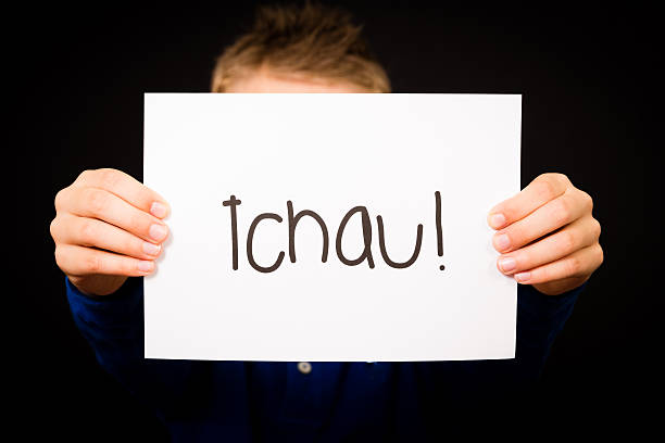 istock Child holding sign with Portuguese word Tchau 480357980