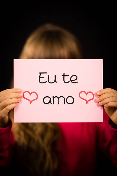 istock Child holding sign with Portuguese words Eu Te Amo 480357988
