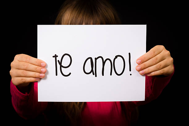 istock Child holding sign with Spanish words Te Amo 480358014