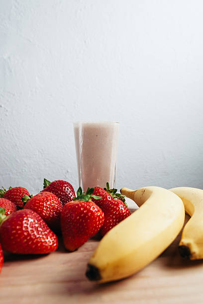 istock strawberry banana smoothie fresh blended on wood table 480361102