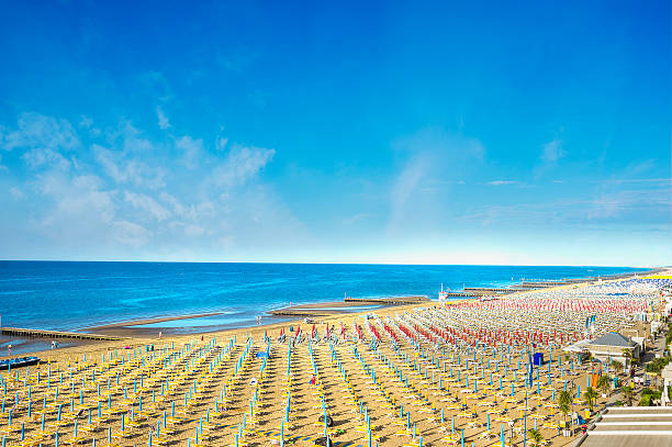istock Sea beach with parasols on ble sky background 480361312