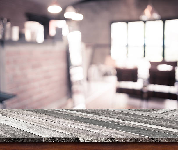 istock Empty wood table top with coffee shop blur with bokeh 480361992