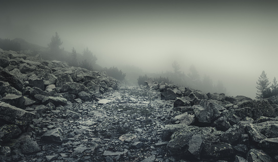 Panoramic shot of misty road in mountains. Stock photo. Bulgaria. Pirin Mountains.