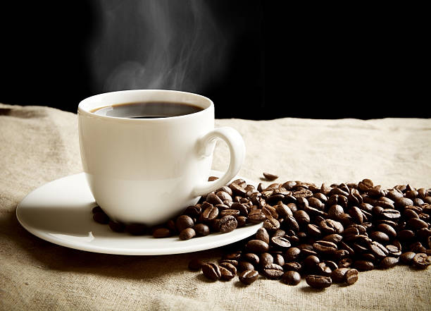 istock Coffee cup with foam with beans on fabric flax 480362860