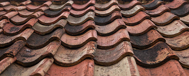 istock The old roof covered with orange tiles 480363316